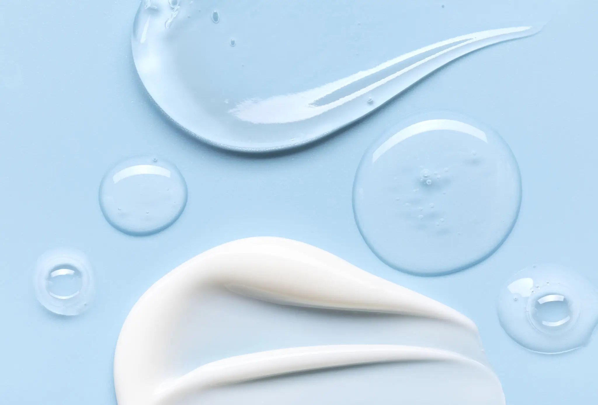 Cream and gel textures on blue background.